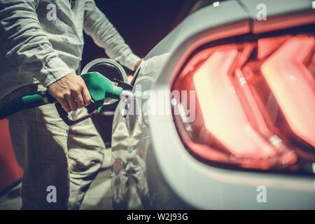 Vehicle Refueling During Night Hours. Car at the Pump. Modern Gas Station Stock Photo