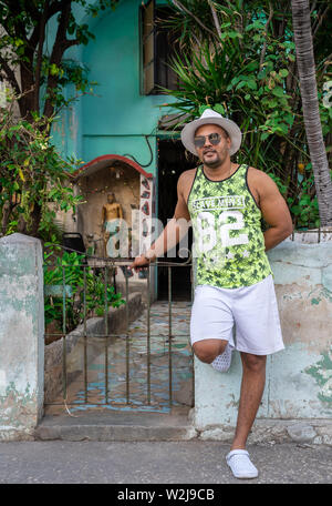 A man in Havana poses for a portrait with a giant Cuban cigar Stock