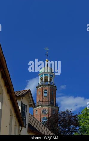 leer, niedersachsen/germany - june 05, 2013: view onto the steeple of grosse kirche ( large church ) and top facades of historical warehouses Stock Photo