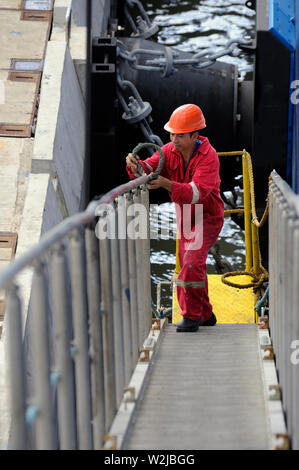 port kelang westport, selangor / malaysia - december 27, 2014: a philippine sailor dismounting the gangway of the containership cma cgm vela (imo 9354 Stock Photo