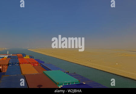 suez canal, egypt - january 06, 2105 -- the containership cma cgm vela ( imo 9354923)  transiting the suez canal near km 82 during a sandstorm, backgr Stock Photo