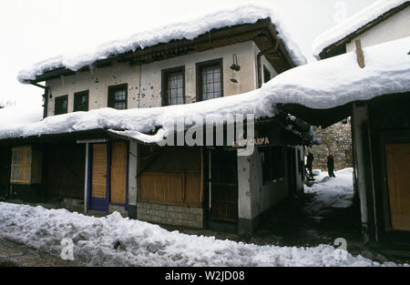 28th March 1993 During the Siege of Sarajevo: shrapnel-damaged closed-up shops in Bascarsija Square in the old town. Stock Photo