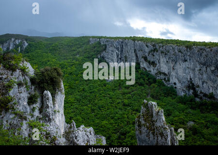 Climbing area. Climbing wall. Vela Draga Valley, Croatia. Vertical mountains in forest middle. Climbing region. Stock Photo