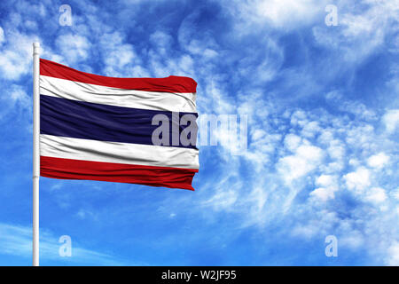 National flag of Thailand on a flagpole in front of blue sky Stock Photo