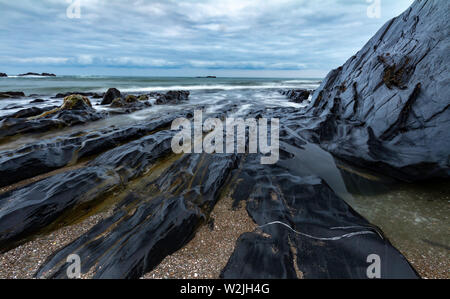 Waves rolling in around the rocks at Ayrmer Cove in Devon Stock Photo