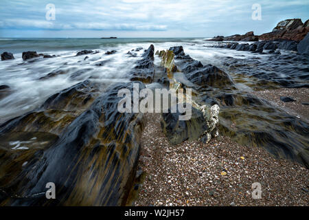 Waves crashing in at Ayrmer Cove in Devon. Stock Photo
