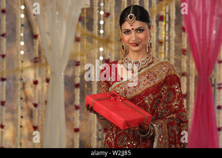 Portrait of an Indian bride holding a gift Stock Photo