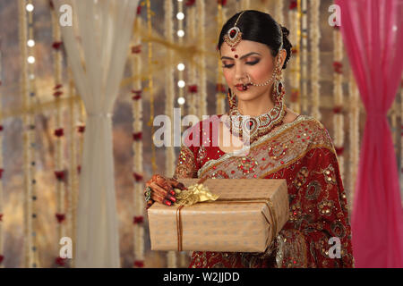 Indian bride holding gift boxes Stock Photo