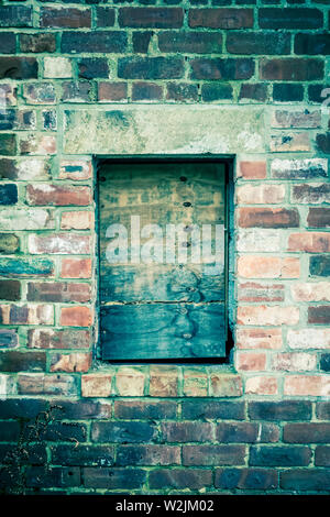 old abandoned brick building with boarded up windows close up Stock ...