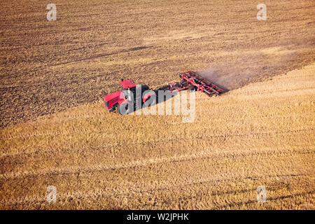 Tractor Working in the Fields, Aerial View. Hay on the field. The view from the top. Tractor harvests dry grass Stock Photo