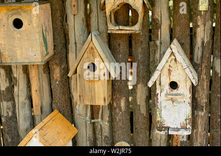 Birdhouses on a wooden fence.Care of birds. Stock Photo