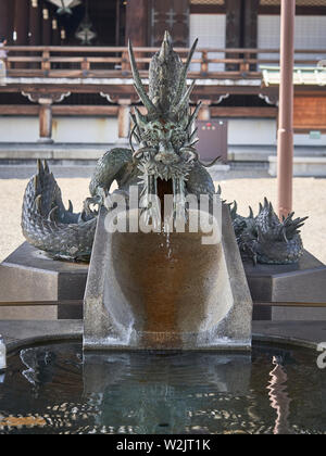 A dragon supplying water at purification fountain of Higashi Hongan-ji in Kyoto, Japan. Stock Photo