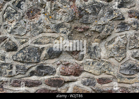 A stone wall of irregularly shaped stone Stock Photo