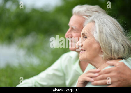 Beautiful senior couple posing in the summer park Stock Photo - Alamy