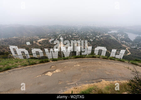 Los Angeles, California, USA - July 7, 2019:  Foggy morning view behind the famous Hollywood Sign in popular Griffith Park.