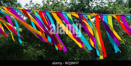 A garland of rainbow-colored fabric scraps. Hippie style. Stock Photo