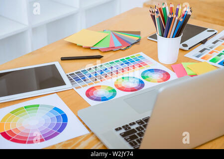 Graphic designer object tool and color swatch samples at workspace. Stock Photo