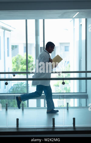 Male doctor running in the corridor at hospital Stock Photo