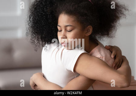 African american little kid girl embracing mother, adoption concept Stock Photo