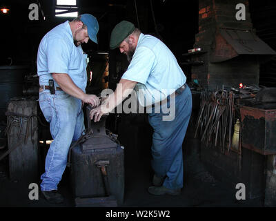 Mystic, CT USA. Oct 2016. Expert blacksmiths at the Mystic Seaport offering workshop classes on traditional maritime metalworking. Stock Photo