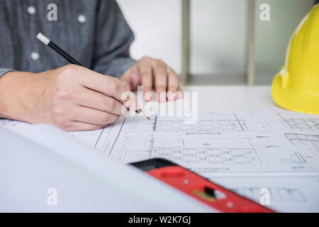 Construction engineering or architect hands working on blueprint inspection in workplace, while checking information drawing and sketching for archite Stock Photo