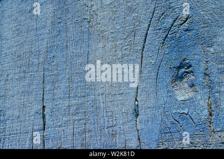 Abstract Rustic aged closeup of barn wood panel painted with light blue faded color. Single piece with vertical wood lines and knot on side Stock Photo