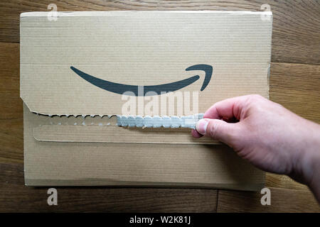 Person opening an Amazon packet Stock Photo