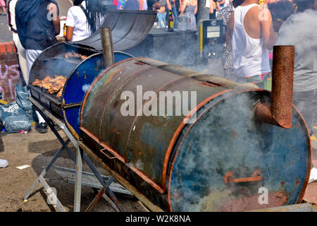 Barbecuing chicken pieces on oil drum barbecue at Bristol St Pauls festival Stock Photo