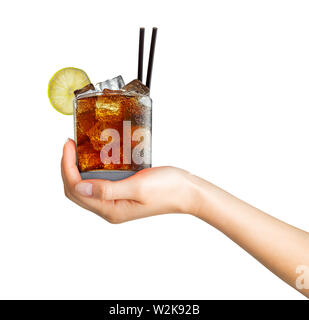 Woman hand holding cocktail in old fashioned glass with ice cubes and black straw on white background. Stock Photo
