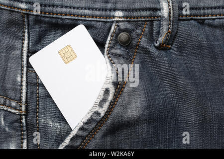Blank white plastic chip card in jeans pocket. White credit card. Stock Photo