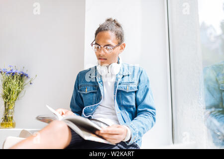 Try to concentrate. Handsome young man wearing glasses while preparing for examination Stock Photo