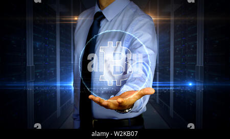 Man with dynamic cryptocurrency transaction and bitcoin symbol hologram on hand. Businessman with futuristic concept of virtual money, ecommerce and f Stock Photo