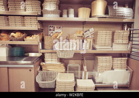 Bread in baskets. Pizza delivery boxes on shelves. Modern restaurant Interior design Stock Photo