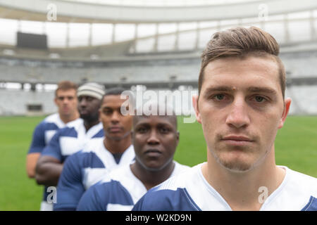 Group of diverse male rugby players standing together in stadium Stock Photo