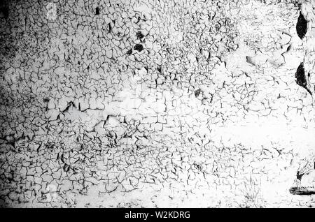 Cracking and peeling paint on a wall. Gray background Stock Photo