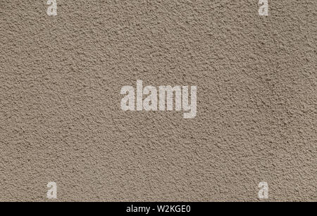 Plastered, painted, rough and beige or light brown concrete or stone wall. High resolution full frame textured background. Stock Photo