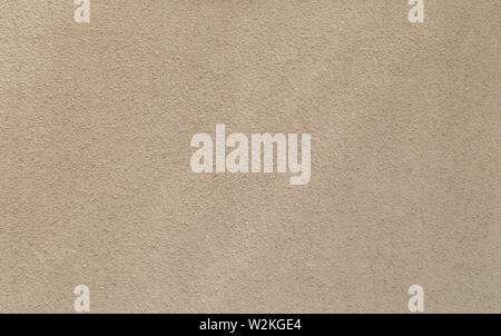 Plastered, painted, rough and beige or light brown concrete or stone wall. High resolution full frame textured background. Stock Photo