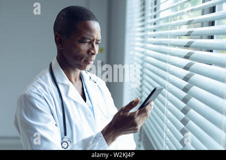 Male doctor using mobile phone in hospital Stock Photo