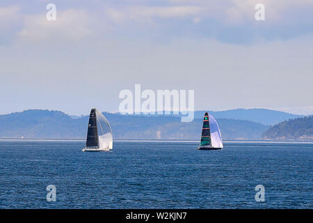 Sailboats taking advantage of a beautiful day in the waters of the San Juan islands in Washington state. Stock Photo