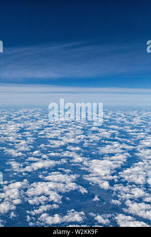 white puffy clouds seen from and airplane Stock Photo