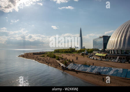 Photo of beach and the embankment of the Neva Bay in the park named after the 300th anniversary of St. Petersburg overlooking the Lakhta Center Stock Photo