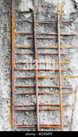Rusted girders exposed in weathered concrete. Stock Photo