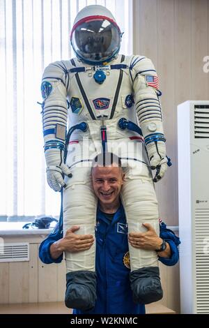 International Space Station Expedition 60 prime crew member Drew Morgan of NASA poses with his Sokol launch and entry suit at the Baikonur Cosmodrome July 5, 2019 in Baikonur, Kazakhstan. Morgan, Skvotsov and Parmitano are expected to launch July 20th on the Soyuz MS-13 spacecraft to the International Space Station. Stock Photo