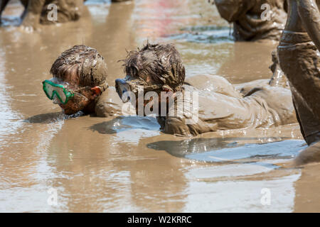 Westland, Michigan - Children age 12 and younger, along with some parents, play in the mud during the annual 'Youth Mud Day' organized by Wayne County Stock Photo