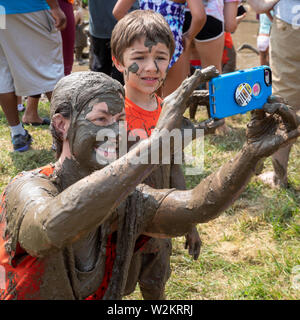 Westland, Michigan - Children age 12 and younger, along with some parents, play in the mud during the annual 'Youth Mud Day' organized by Wayne County Stock Photo