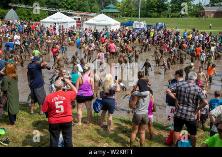 Westland, Michigan - Children age 12 and younger, along with some parents, play in the mud during the annual 'Youth Mud Day' organized by Wayne County Stock Photo