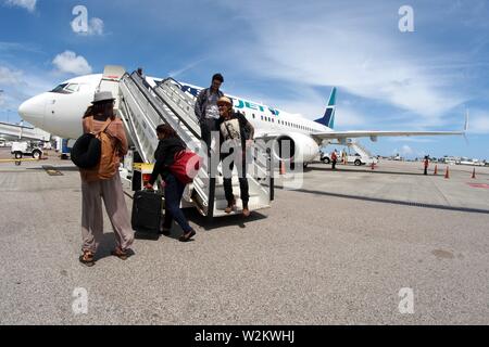 Westjet from Toronto, disembarking at SXM, Princess Juliana International Airport, St Maartens, Caribbean. Stock Photo