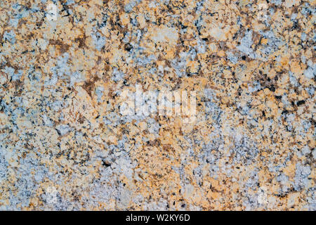 Yellow and grey granite wall with quarts and smooth surface as background Stock Photo