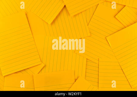 stack of blank rectangular paper orange sheet background pattern, top view with copy space. Stock Photo