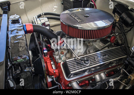 A view of the Edelbrock valve cover and the surroundings in the engine compartment. Refurbished American car. Stock Photo